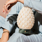 Cordless table lamp Serena Ice Green marble, textured porcelain shade held close in hand