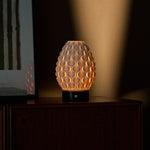 Serena rechargeable table lamp with Nero Marquina black marble base on a dark wood dresser