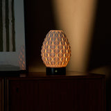 Serena rechargeable table lamp with Nero Marquina black marble base on a dark wood dresser