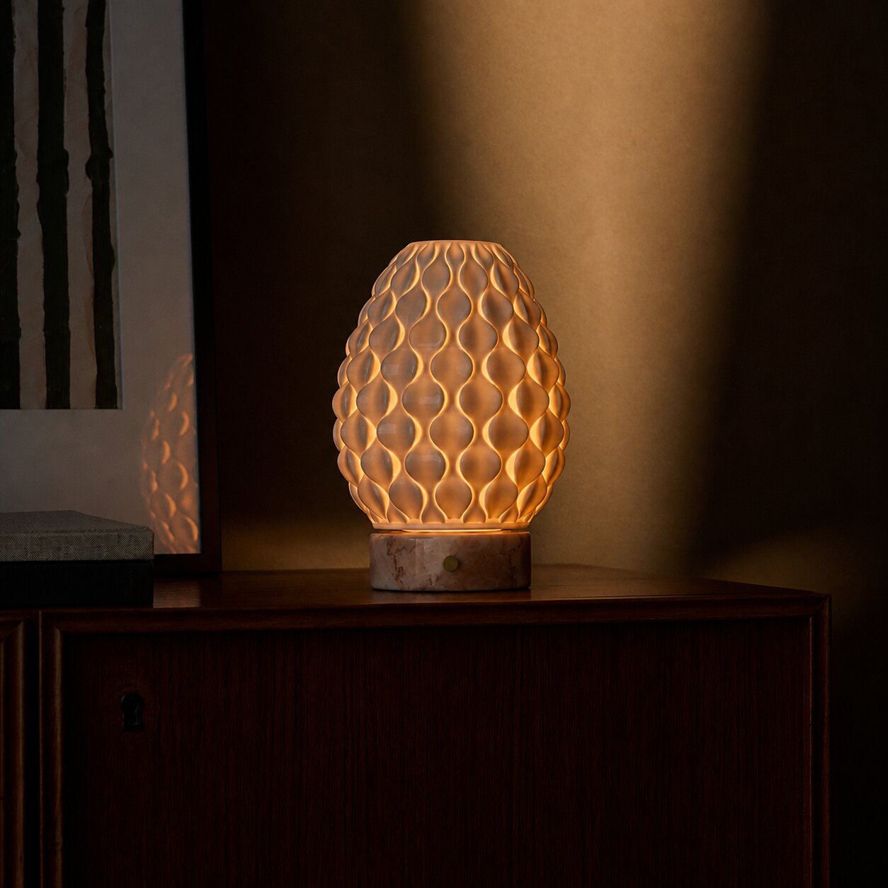 Cordless table lamp Serena Rosa Aurora marble, warm porcelain shade on dark wood sideboard