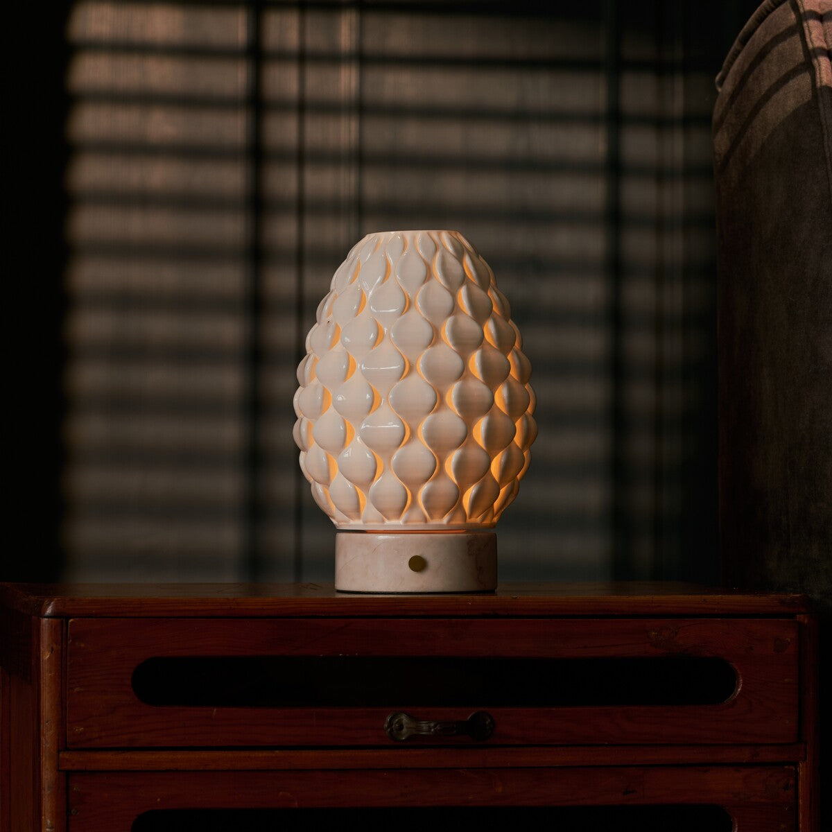 Cordless table lamp Serena Rosa Aurora marble, glowing porcelain shade on vintage wooden dresser