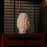 Cordless table lamp Serena Rosa Aurora marble, glowing porcelain shade on vintage wooden dresser