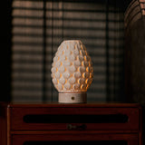 Cordless table lamp Serena Rosa Aurora marble, glowing porcelain shade on vintage wooden dresser