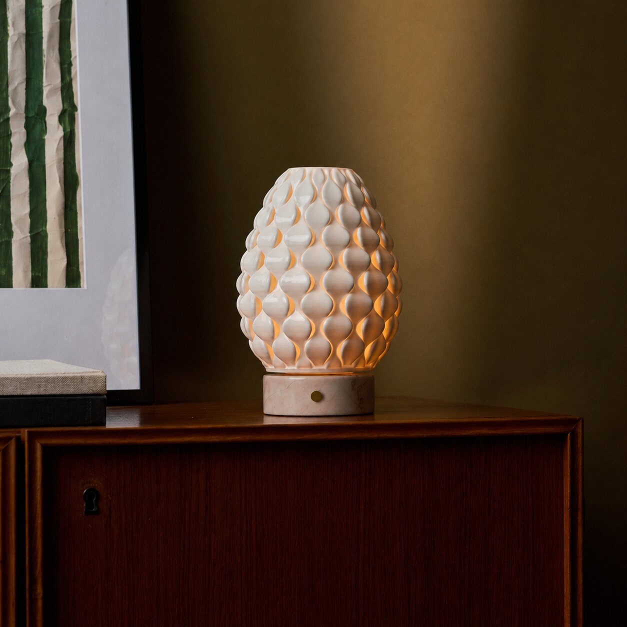 Rechargeable table lamp Serena Rosa Aurora marble, glowing cream shade on walnut sideboard