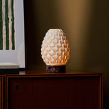 Close-up of the Serena Rosso Levanto rechargeable table lamp's red marble base held on someone's lap