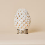 Rechargeable table lamp Serena silver travertine with scalloped porcelain shade, studio shot