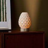 Rechargeable table lamp Serena silver travertine porcelain shade beside framed green wall art