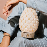Rechargeable table lamp Serena silver travertine porcelain shade held in hand, close-up detail