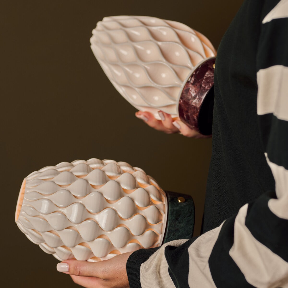 Serena Verde Alpi and Rosso Levanto marble table lamps compared side by side, held in hand