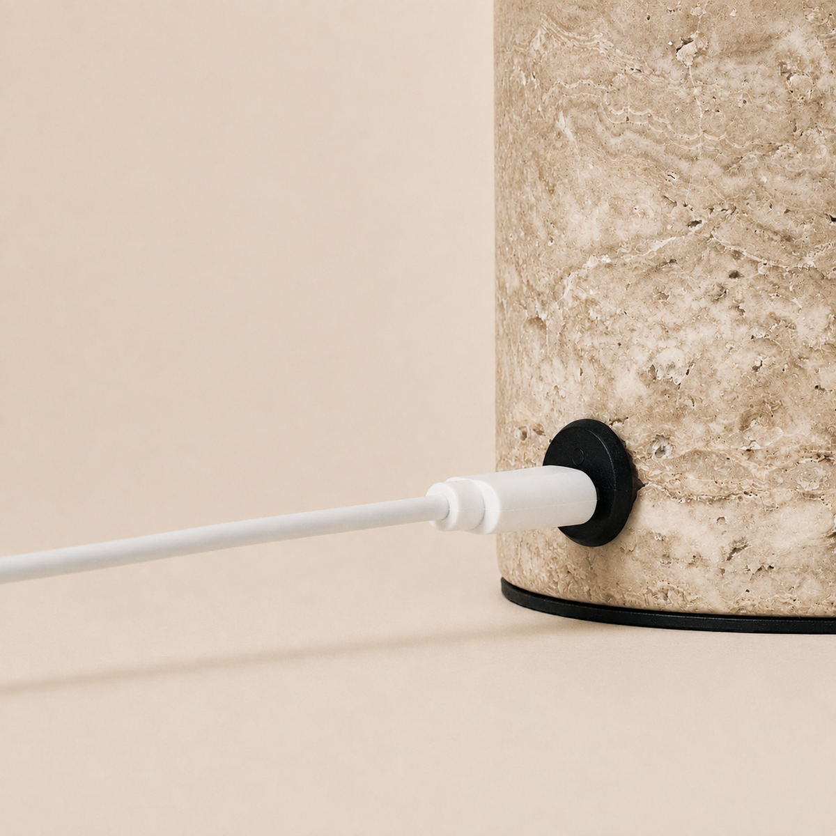Close-up of the silver travertine base on the Dou rechargeable table lamp showing its USB-C port