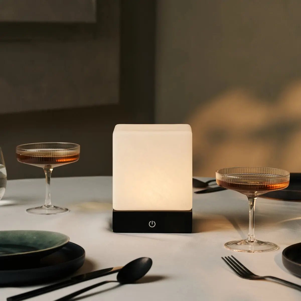 Sleek design of Yce Black Lamp with Frozen Glass on a side table