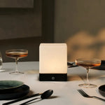 Sleek design of Yce Black Lamp with Frozen Glass on a side table