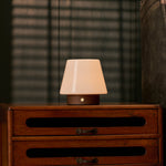 Oplaadbare tafellamp Jadey donkerbruin hout brandend op een houten dressoir 's avonds