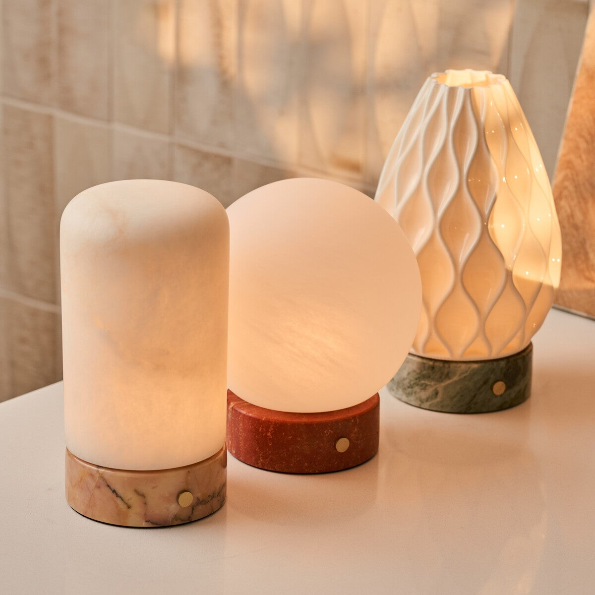 Levora collection rechargeable table lamps in alabaster with pink, red and green marble bases