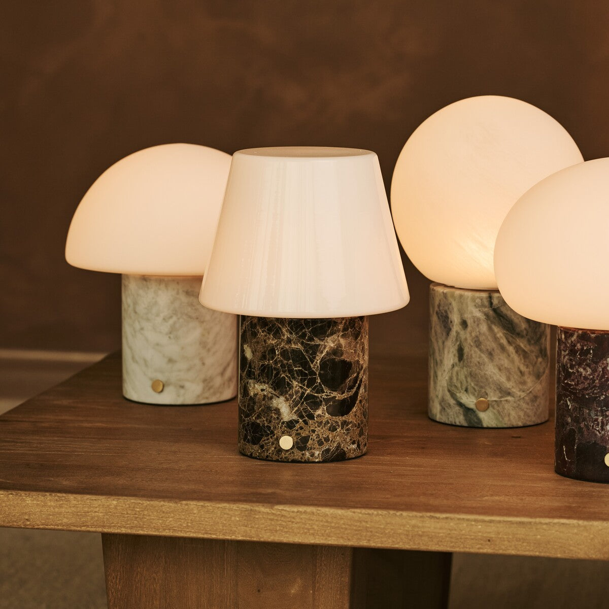 Tavellio Rijks Collection rechargeable table lamps in assorted marble tones on a wooden table