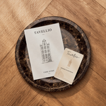 Tavellio user guide and Amsterdam-designed card resting on a dark marble tray