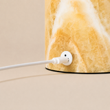 Close-up of the Honey Onyx marble base and USB charging port on the Maes table lamp