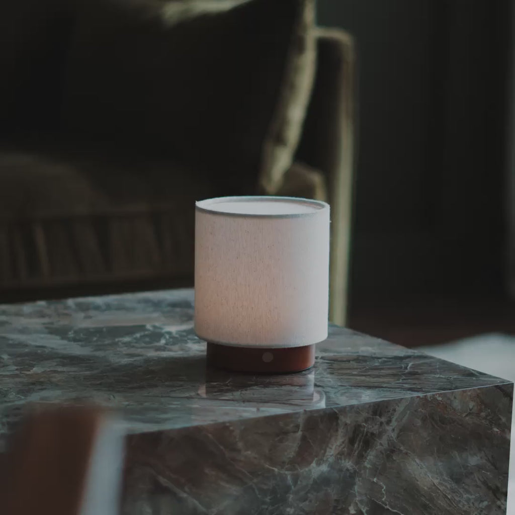 Short video of Tavellio rechargeable table lamps with linen shades, lit in a cosy living room